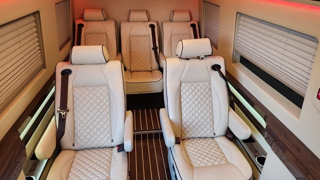 Facing cream leather captain's chairs in the Executive Sprinter cabin